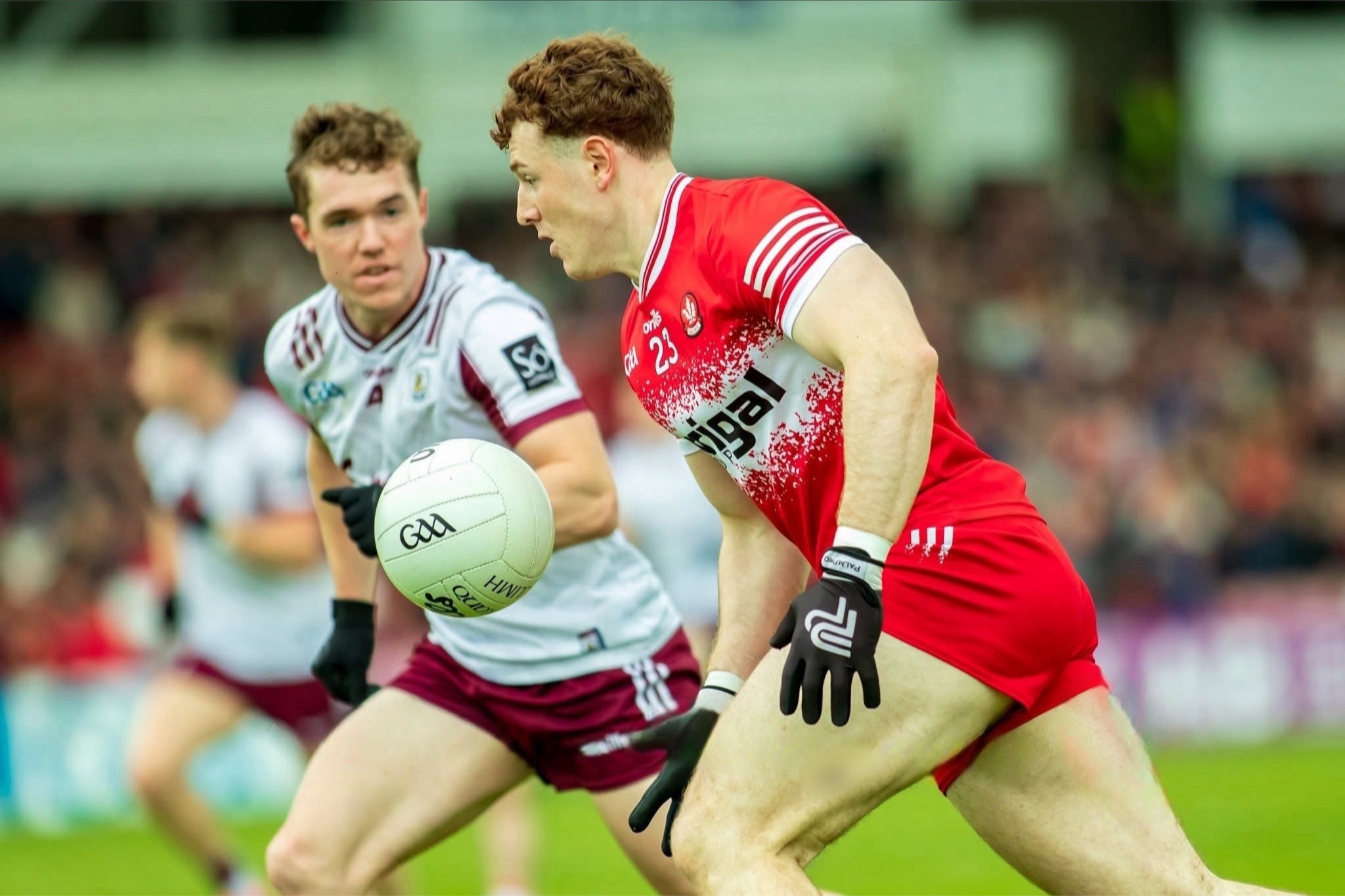 Gaelic footballer wearing PalmPro gloves in match action